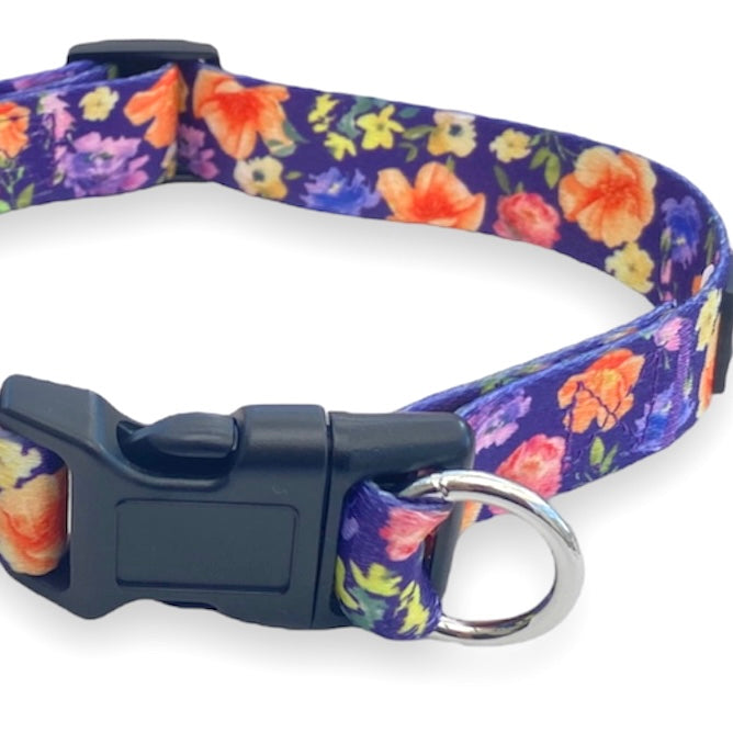 a close up photo of a purple floral dog collar buckle